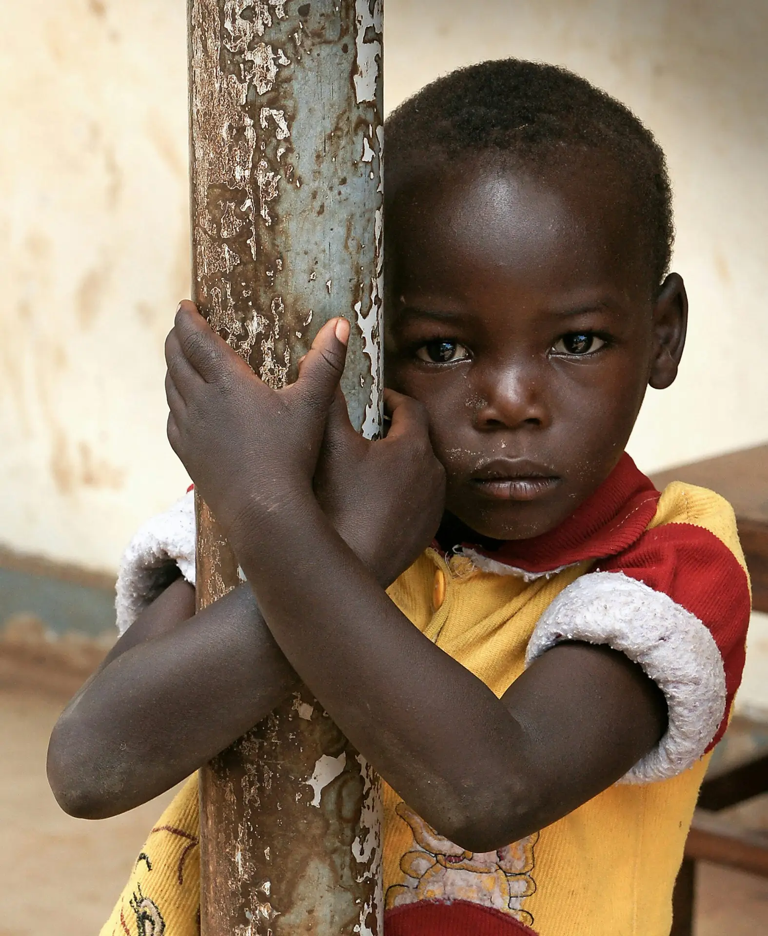 child standing holding a pole